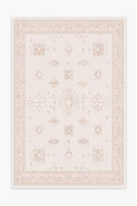 Verena soft pink rug - Pretty in pink. Our Verena Soft Pink Rug uses a range of soft pinks, calming teals, and relaxing purples to put a modern spin on a traditional Persian-style distressed design. It features an ornate border around a grid of geometric shapes reminiscent of embellished jewels, while the pale pink background offers a cheerf